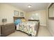 Bedroom with colorful quilt, neutral walls and carpet, and wood furniture at 1605 Heritage Club Ave, Wake Forest, NC 27587