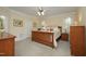 Comfortable bedroom with a ceiling fan, wood furnishings, neutral walls and carpet at 1605 Heritage Club Ave, Wake Forest, NC 27587
