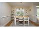 Bright dining room featuring a wood table, seating for four, and elegant decor at 1605 Heritage Club Ave, Wake Forest, NC 27587