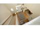 View of foyer from above, showing front door and staircase with carpet runner at 1605 Heritage Club Ave, Wake Forest, NC 27587