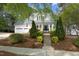 Charming two-story home with manicured front yard and inviting entrance staircase at 1605 Heritage Club Ave, Wake Forest, NC 27587
