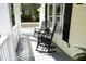 Inviting front porch with rocking chairs, creating a cozy outdoor space at 1605 Heritage Club Ave, Wake Forest, NC 27587