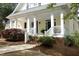 Inviting front porch with classic white columns and charming brick-lined steps at 1605 Heritage Club Ave, Wake Forest, NC 27587