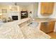 Open kitchen featuring granite counters, stainless appliances, and a view of the inviting living room at 1605 Heritage Club Ave, Wake Forest, NC 27587