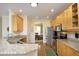 Well-equipped kitchen featuring granite countertops, stainless steel appliances, and ample wood cabinetry at 1605 Heritage Club Ave, Wake Forest, NC 27587