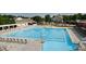 Community pool area featuring a large pool, sun loungers, umbrellas and playground equipment at 1605 Heritage Club Ave, Wake Forest, NC 27587