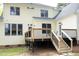 Back exterior view of the house with a spacious back deck and stairs leading to the yard at 1605 Heritage Club Ave, Wake Forest, NC 27587