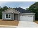 Charming one-story home with a two-car garage and a well-manicured lawn at 161 Tupelo Dr, Spring Hope, NC 27882