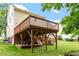 Exterior view of a home with a wood deck, backyard and mature trees at 1614 Finnsbury Dr, Burlington, NC 27217