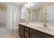 Bathroom with double vanity, framed mirror, shower and white shower curtain at 1614 Finnsbury Dr, Burlington, NC 27217