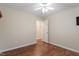 Neutral bedroom with ceiling fan, wood floors and white doors at 1614 Finnsbury Dr, Burlington, NC 27217