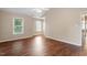 A bright bedroom with hardwood floors, lots of natural light from the large windows, and a ceiling fan at 1614 Finnsbury Dr, Burlington, NC 27217