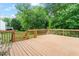 Wood deck with wood railing and lush surrounding landscape at 1614 Finnsbury Dr, Burlington, NC 27217