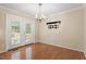 Dining room with hardwood floors, chandelier, and French doors leading to the backyard at 1614 Finnsbury Dr, Burlington, NC 27217