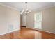 Dining room featuring hardwood floors, neutral color palette, and a chandelier at 1614 Finnsbury Dr, Burlington, NC 27217