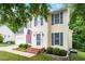 Charming two-story home with blue shutters and landscaped front yard at 1614 Finnsbury Dr, Burlington, NC 27217