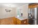 A kitchen island with granite countertops and stainless steel appliances nearby, giving a wide view to the dining area at 1614 Finnsbury Dr, Burlington, NC 27217