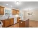 A modern kitchen with stainless steel appliances, a double sink and a kitchen island overlooking the dining area at 1614 Finnsbury Dr, Burlington, NC 27217