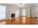 Bright living room featuring hardwood floors, a fireplace, and large windows at 1614 Finnsbury Dr, Burlington, NC 27217