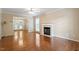 Spacious living room featuring a fireplace, hardwood floors, a ceiling fan, and ample natural light at 1614 Finnsbury Dr, Burlington, NC 27217