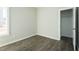 This bedroom features gray walls, white trim, wood-look flooring, and a closet at 175 Tupelo Dr, Spring Hope, NC 27882