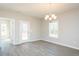 Dining area with modern chandelier, views to the backyard, and stylish lighting at 175 Tupelo Dr, Spring Hope, NC 27882