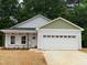 Charming new construction home featuring a two-car garage, covered porch, and gray vinyl siding at 175 Tupelo Dr, Spring Hope, NC 27882