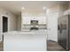 Open kitchen featuring an island, stainless steel appliances, and white cabinets at 175 Tupelo Dr, Spring Hope, NC 27882