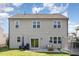 Back exterior of the home showcasing the large windows, patio, grill, and trampoline at 19 Cecina Ct, Clayton, NC 27527