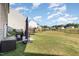 Large backyard with a well-maintained lawn, trampoline, grill, and a fenced perimeter at 19 Cecina Ct, Clayton, NC 27527