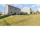 Spacious backyard with a well-manicured lawn, fenced perimeter, trampoline and grill at 19 Cecina Ct, Clayton, NC 27527