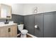 Stylish half bathroom with wood paneling, designer sink, and modern fixtures at 19 Cecina Ct, Clayton, NC 27527
