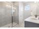 Clean and modern bathroom featuring a tiled shower, vanity, and tile flooring at 19 Cecina Ct, Clayton, NC 27527