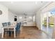 Dining area open to the living room with outdoor views through sliding glass doors to the patio at 19 Cecina Ct, Clayton, NC 27527