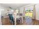 Dining area adjacent to the living room, featuring a view to the backyard, natural light, and seating for four at 19 Cecina Ct, Clayton, NC 27527