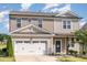 Attractive two-story home with a welcoming front door and a spacious two car garage at 19 Cecina Ct, Clayton, NC 27527