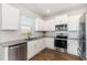 Bright kitchen with stainless appliances, white cabinets, subway tile backsplash and hardwood floors at 19 Cecina Ct, Clayton, NC 27527