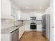 Clean kitchen with stainless steel appliances, white cabinets and subway tile backsplash at 19 Cecina Ct, Clayton, NC 27527