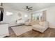 Spacious living room with a large sectional couch, ceiling fan, hardwood floors, and plenty of natural light at 19 Cecina Ct, Clayton, NC 27527