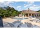 Community pool area with lounge chairs and a mushroom fountain, surrounded by lush trees and a well-maintained pool house at 19 Cecina Ct, Clayton, NC 27527