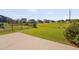Spacious backyard featuring green grass, a black fence, and a concrete patio at 1904 Birdhouse Ln, Wake Forest, NC 27587