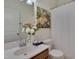 Cozy bathroom featuring a single sink, modern faucet, and decorative floral artwork at 1904 Birdhouse Ln, Wake Forest, NC 27587