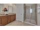 Bathroom featuring a glass shower enclosure, dual vanity, granite counters, and tile flooring at 1904 Birdhouse Ln, Wake Forest, NC 27587