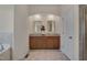 Bathroom with dual vanity, tile floors, granite counters, undermount sinks, and wood cabinets at 1904 Birdhouse Ln, Wake Forest, NC 27587