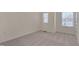 Bright bedroom with two windows, neutral carpeting, and walls offering a flexible space at 1904 Birdhouse Ln, Wake Forest, NC 27587