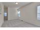 Bedroom with a view and filled with natural light, neutral paint, and plush carpet at 1904 Birdhouse Ln, Wake Forest, NC 27587