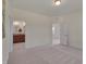 This primary bedroom features a neutral color palette, carpet flooring, and ensuite bathroom access at 1904 Birdhouse Ln, Wake Forest, NC 27587