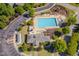 Aerial view of the community pool with sundeck, playground, and trees for shade at 1904 Birdhouse Ln, Wake Forest, NC 27587