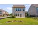 Well-maintained two-story home featuring a green lawn, patio, and neatly trimmed shrubbery at 1904 Birdhouse Ln, Wake Forest, NC 27587