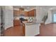 Modern kitchen with stainless steel appliances, granite countertops, and wood cabinets, seamlessly connected to living area at 1904 Birdhouse Ln, Wake Forest, NC 27587